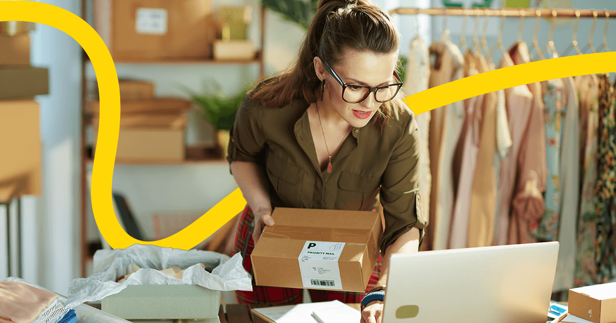 A woman checking her computer to look at her shopify store and check orders.