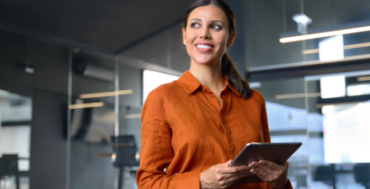 Woman smiling and holding a tablet